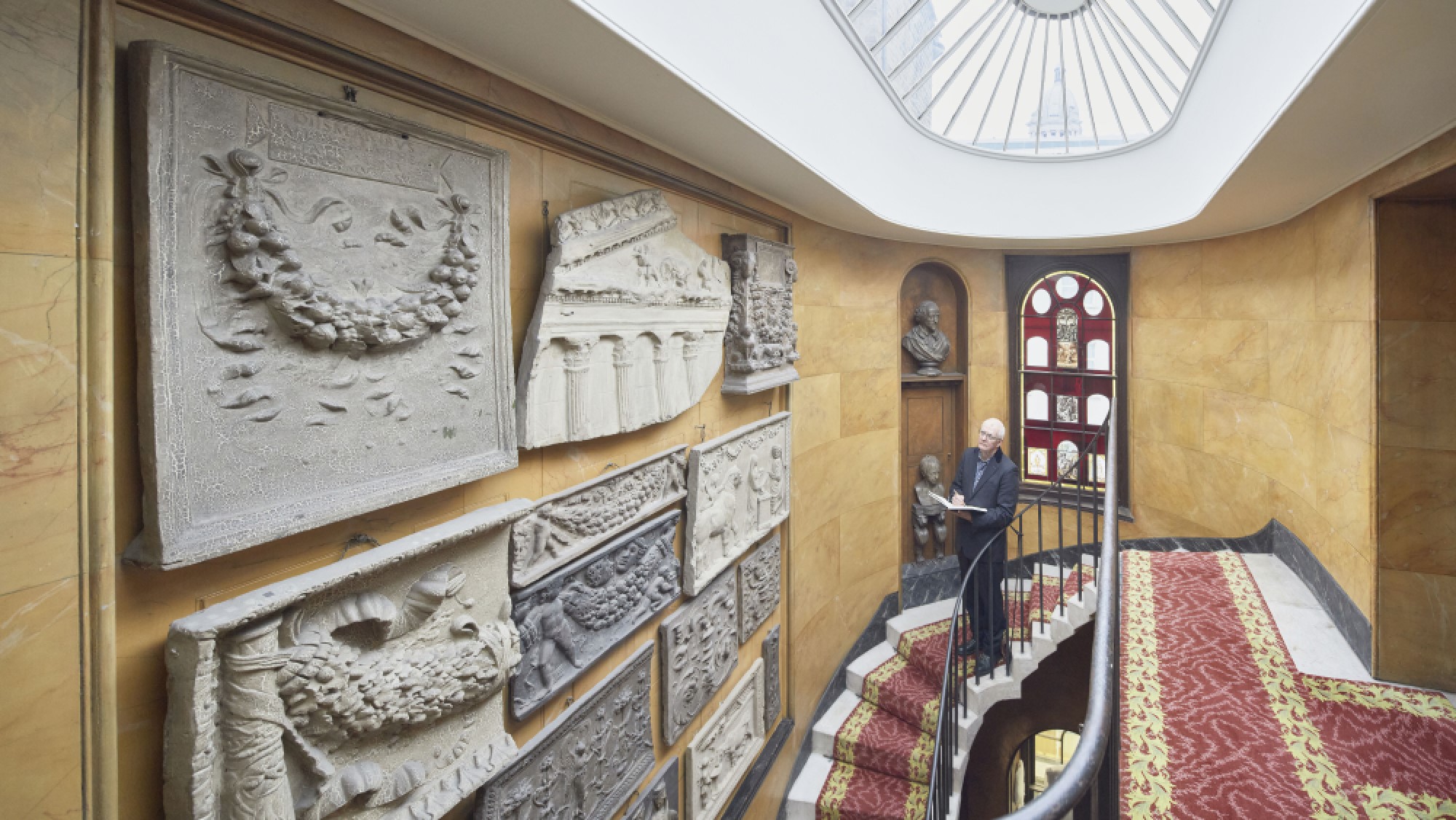 Ken Shuttleworth stands at the top of the no.13 staircase and draws casts on the walls