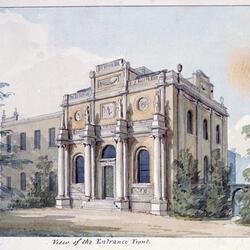 Perspective view of Pitzhanger Manor, a yellow-walled house with Roman columns on the front, surrounded by trees and a lawn