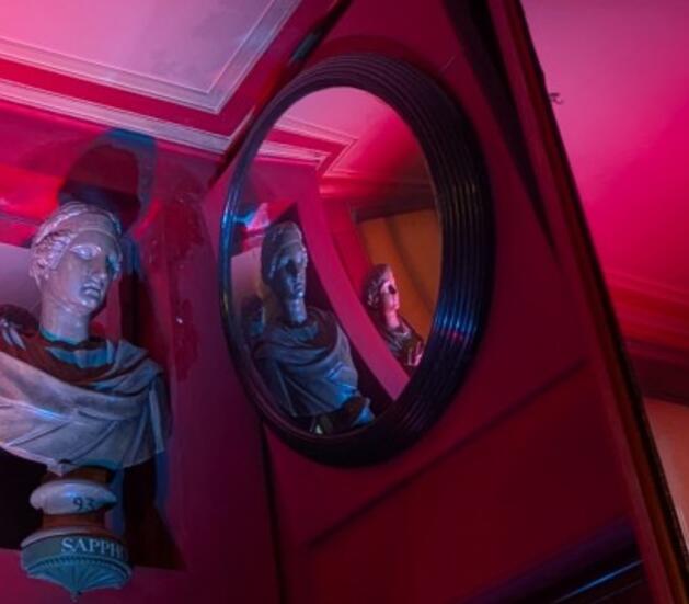 A bust of Sapho opposite and reflected in a convex mirror