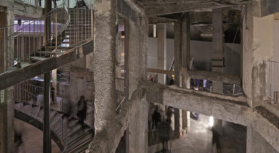 The internal skeletal structure of the Palais de Tokyo, with a spiral staircase descending through the layers of the building.