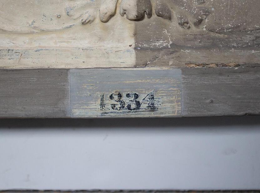 A detail of the cast mid-restoration, showing the number 1334 in black serif lettering.