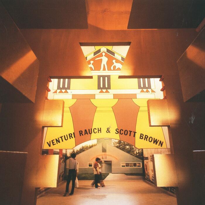 Photo of Venturi Scott Brown's facade at the first Venice Architecture Biennale, an orange and yellow postmodern structure with classical elements