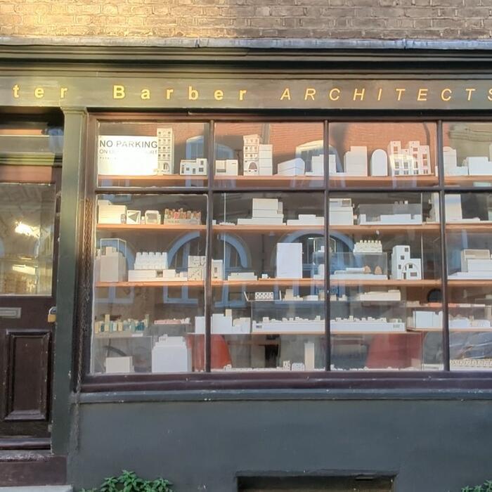 The green frontage of Peter Barber Architects. The former shop window is full of architectural models.