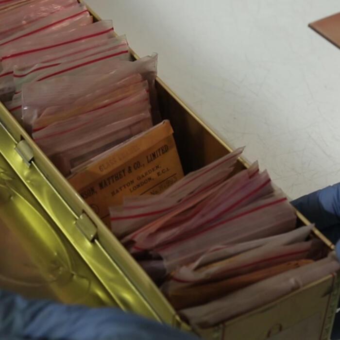Different pigment sachets stored in an old whisky tin