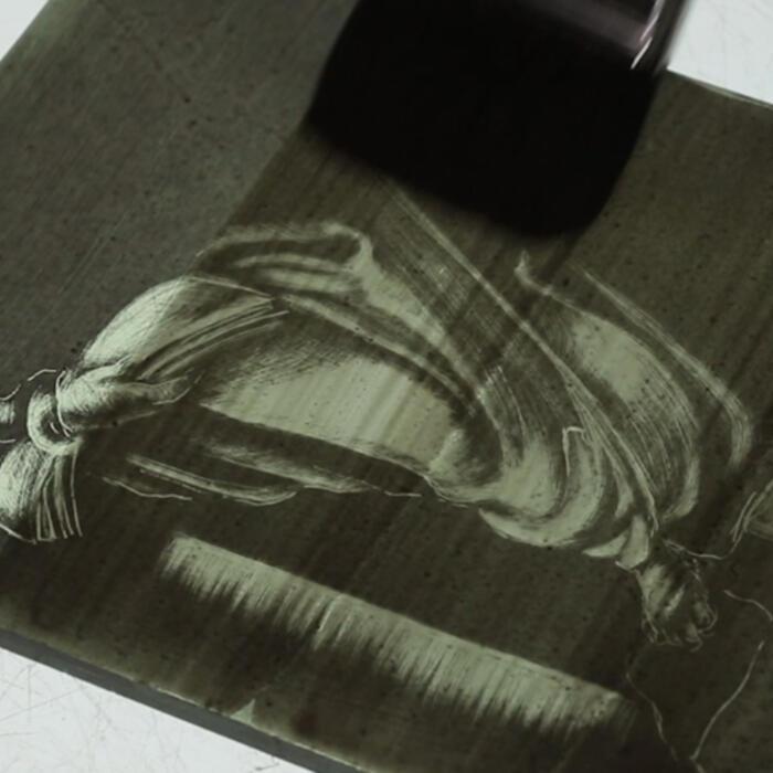 An etched stained glass panel with a second layer of matt being brushed over the top