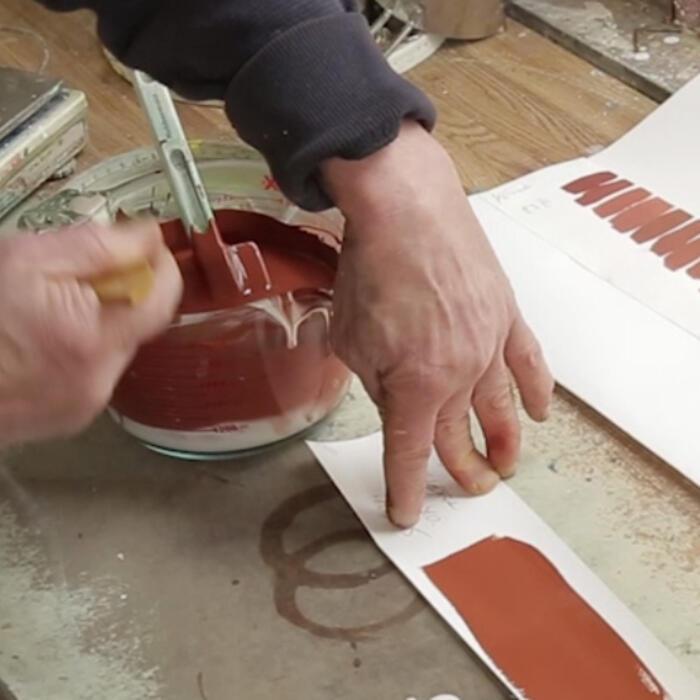 A conservator blending the pigment and some nearby samples of the pigment