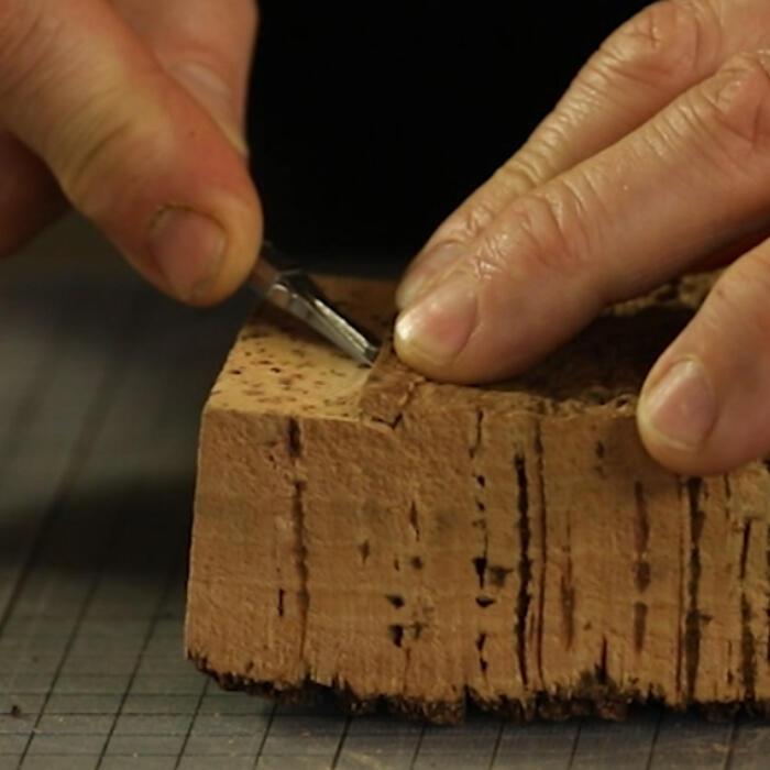 Cutting into a block of cork