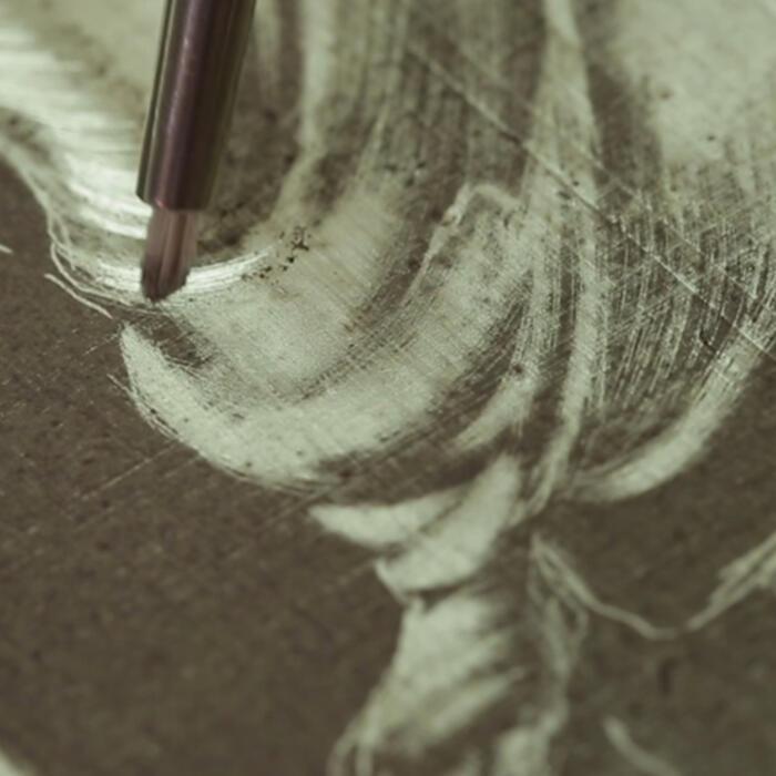 The second stage of etching a stained glass panel, etching into the figure to create highlights