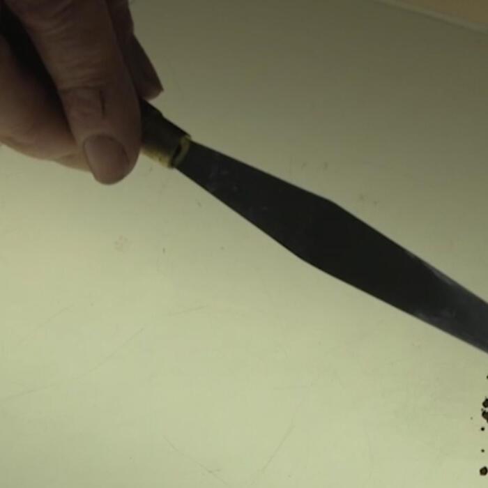 A palette knife putting some pigment on a palette