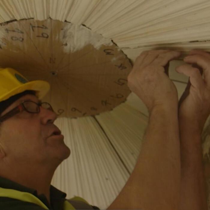 Neil England sticking a lath to a ceiling