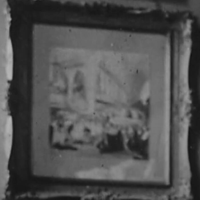 Blurry, black and white photograph showing a picture in its frame