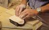 A person making a mould for part of a frame