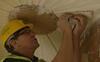 Neil England sticking up a plaster ceiling