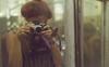 Photograph of Denise Scott Brown taking a photograph of herself in a mirror