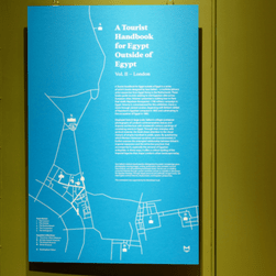 A green wall with a blue panel, showing a map of sites in London and text.