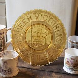 Translucent yellow glassware celebrating fifty years of Queen Victoria's reign, bearing the years of her rule and a royal coat of arms.