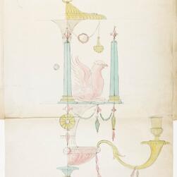 Hand-drawn design sketch of an ornate wall sconce featuring decorative elements. The design includes two tall blue columns supporting a pink sculpted bird with wings raised, a yellow curved arm holding a candle holder, and multiple hanging ornaments in pastel colors. The drawing is annotated at the top with handwritten text and shows intricate neoclassical detailing.