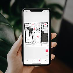 Hand holding a phone displaying a map of the Soane Museum