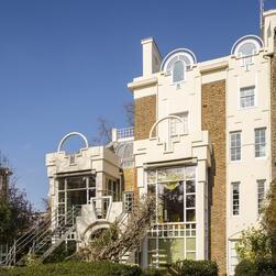 The rear elevation of Cosmic House, showing the large ground floor windows looking out over the garden.