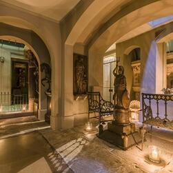 Photograph of the Crypt facing East. The Crypt is alight with candles, which are illuminating a statue of Britannica.
