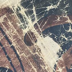 A close-up view of damage to the paint layer of a transparency before restoration.