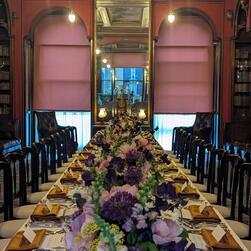 Pink and purple flower arrangements against a symmetrical window backdrop