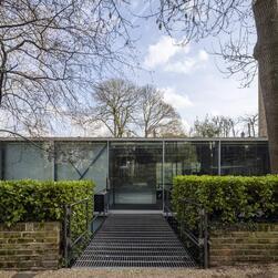 The front entrance of Hopkins House, reached from pavement level by a sleek, simple bridge.