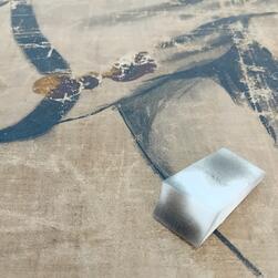 A small sponge covered in dirt removed from the transparency.