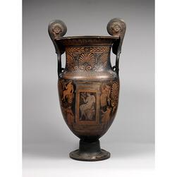 A vase decorated with orange figures upon a dark background, with an image of a seated youth