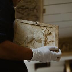 A restored cast is returned to the ceiling of the Drawing Office during the restoration process.