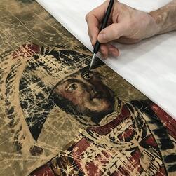 A conservator re-touches Wellington's face.