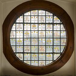 A circular stained glass window at Red House.