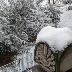 Snow on a decorative stone piece