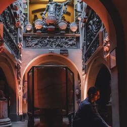 A member of the Museum team adjust lighting in the crypt area, next to the sarcophagus.