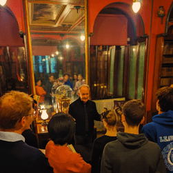 A VA talking to a tour group at the North end of the Library-Dining Room.