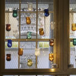 A display in the Museum's Back Kitchen window inspired by the oil light illuminations of Vauxhall Pleasure Gardens.