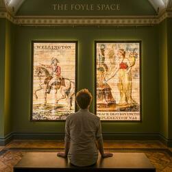 A visitor enjoys the illuminated transparencies in the Foyle Space.
